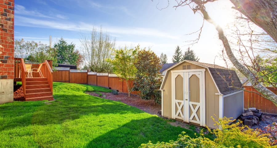 Fenced backyard with storage shed in Muncie